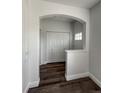 Bright entryway with white trim, wood flooring, and a large coat closet at 12783 Ivy St, Thornton, CO 80602