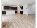 Open-concept living space featuring a modern kitchen, wood flooring, and plenty of natural light at 1290 Loraine N Cir, Lafayette, CO 80026