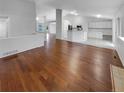 Spacious living area flows into the kitchen with hardwood floors and neutral paint at 5236 S Liverpool Way, Centennial, CO 80015
