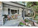 Inviting covered front porch featuring stone accents and a cozy seating area, perfect for relaxing at 4338 S Alton St, Greenwood Village, CO 80111