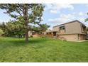 Spacious lawn with mature trees surrounding the home at 141 S Upham Ct, Lakewood, CO 80226