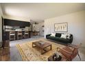 Bright and airy living room with an open floor plan that flows into the dining area and modern kitchen at 645 Manhattan Pl # 106, Boulder, CO 80303