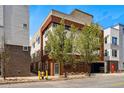 Modern exterior building with a brick facade, unique architecture, and attached parking garage in urban neighborhood at 4539 Tennyson St # 105, Denver, CO 80212
