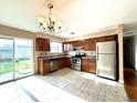 Well-lit kitchen featuring stainless steel appliances, tile flooring, and sliding door access to the backyard at 4312 S Xenon St, Morrison, CO 80465