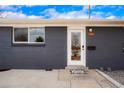 Close up of the front door and brick of the gray home at 9101 Clarkson St, Thornton, CO 80229