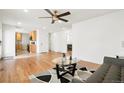 Open-concept living room with hardwood floors, stylish decor, and bright kitchen at 9101 Clarkson St, Thornton, CO 80229