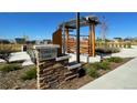 Beautifully landscaped entrance to Orion Park featuring stone pillars and pergola at 28645 E 6Th Pl, Watkins, CO 80137