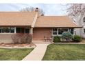Inviting front porch with chairs and plants, perfect for relaxing outdoors at 2250 N Monaco Pkwy, Denver, CO 80207