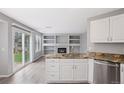 Modern kitchen open to living space features an island, granite countertops, and stainless appliances at 20481 E Mansfield Pl, Aurora, CO 80013