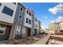 Exterior view of modern townhomes with stylish blue and white accents at 14265 Currant St, Broomfield, CO 80020