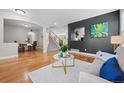 Open living space with hardwood floors, staircase, and elegant archways at 12942 Leyden St, Thornton, CO 80602