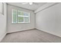 Minimalist bedroom with a ceiling fan, grey carpet and large windows allowing ample natural light at 2893 W 10Th Ave, Denver, CO 80204