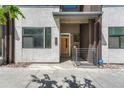 Modern townhome featuring clean architectural lines, a natural wood front door, and convenient street-side access at 2893 W 10Th Ave, Denver, CO 80204