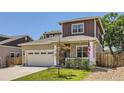 Charming home featuring a well-manicured lawn, an American flag, and a spacious two-car garage at 7933 Florado St, Denver, CO 80221