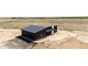 Stunning overhead view of a modern home on a large lot, complete with an attached garage and covered porch at 65960 E Evans Pl, Byers, CO 80103