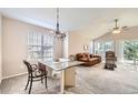 Inviting living room area with vaulted ceilings, a ceiling fan and lots of natural light at 7774 S Biloxi Way, Aurora, CO 80016