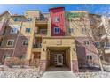 Exterior view of a well-maintained building with brick accents, multiple balconies, and clearly marked unit number at 1162 Rockhurst Dr # 404, Highlands Ranch, CO 80129