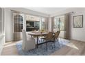 Bright dining room with large windows, modern furnishings, and elegant decor creating an inviting space at 11490 Autumn Moon St, Littleton, CO 80125