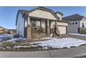 Two-story house with a front porch, landscaping, and driveway at 592 Bristolwood Ln, Castle Pines, CO 80108