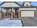 House exterior showcasing a front porch and attached garage at 592 Bristolwood Ln, Castle Pines, CO 80108