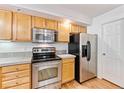 Well-maintained kitchen featuring modern stainless steel appliances and wooden cabinetry at 2330 S Salem Cir, Aurora, CO 80014