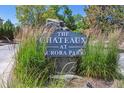 Community sign for The Chateaux at Aurora Park, surrounded by plants at 2330 S Salem Cir, Aurora, CO 80014