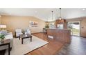 Open-concept living space with hardwood floors, eat-in dining area, and stainless steel appliances at 4080 E Caley Cir, Centennial, CO 80121