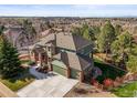 An aerial view of a lovely two-story home, a three-car garage and a scenic neighborhood at 10831 Eagle Crest Ln, Parker, CO 80138