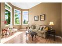 Bright living room featuring large windows, wood floors, and stylish decor at 10831 Eagle Crest Ln, Parker, CO 80138