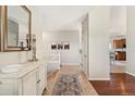 Elegant entryway with decorative mirror and console table flows into an open-concept living space at 3047 Deer Creek Ranch Loop, Parker, CO 80138