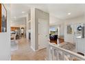 Bright foyer showcases an open floor plan with views of the living room, kitchen, and staircase at 3047 Deer Creek Ranch Loop, Parker, CO 80138