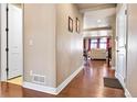 Inviting hallway with hardwood floors leading to a bright living space at 18101 E 44Th Pl, Denver, CO 80249
