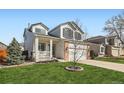 Inviting two-story home with a charming front porch and well-maintained lawn at 398 Benton St, Castle Rock, CO 80104