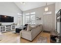 Bright living room featuring high ceilings, hardwood floors and neutral color palette at 4733 Flower St, Wheat Ridge, CO 80033