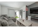 Cozy living room with balcony, gray couch, fireplace, and modern decor at 532 Oakwood Dr # D202, Castle Rock, CO 80104