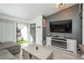 Open living room with modern decor, fireplace, tv, and balcony access at 532 Oakwood Dr # D202, Castle Rock, CO 80104