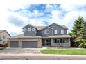 Charming two-story home featuring a three-car garage and a welcoming front porch at 14962 Williams St, Thornton, CO 80602
