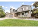 Charming two-story home with a well-manicured lawn and front porch at 14962 Williams St, Thornton, CO 80602