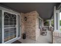 Inviting front porch with brick accents, decorative plants, and seating area at 14962 Williams St, Thornton, CO 80602