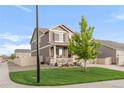 A charming two-story home with a well-manicured lawn and attractive landscaping on a sunny day at 6922 Vermillion St, Frederick, CO 80530