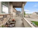 Inviting front porch featuring stone accents, white railing, and space to relax outdoors at 6922 Vermillion St, Frederick, CO 80530