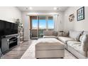 Cozy living room with sliding glass doors to the patio providing natural light and space for relaxing at 9287 Twenty Mile Rd # 204, Parker, CO 80134