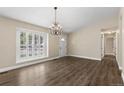 Bright living room showcasing hardwood floors, a large window with shutters, and neutral wall color at 142 S Fillmore Ave, Louisville, CO 80027