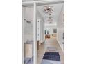 Bright foyer showcasing chandelier lighting, hardwood floors, and stylish decor at 936 Sunflower St, Louisville, CO 80027