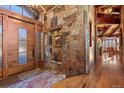 Beautiful foyer featuring a stone wall and a wood door at 220 Cottonwood Cir, Breckenridge, CO 80424