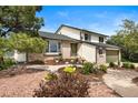 Charming home boasts a two-car garage, brick accents, and lush landscaping, creating a welcoming curb appeal at 225 Briscoe Ln, Castle Rock, CO 80109