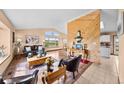 Inviting living room features wood floors, vaulted ceilings, and large windows showcasing scenic views at 225 Briscoe Ln, Castle Rock, CO 80109