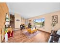 Comfortable living room with wood floors and a large picture window offering scenic views at 225 Briscoe Ln, Castle Rock, CO 80109