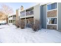 Condo building exterior with snowy landscape and landscaping at 943 S Zeno Way # 206, Aurora, CO 80017