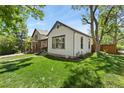 Exterior side view of home with green lawn, mature tree and nice landscaping at 300 E Cleveland St, Lafayette, CO 80026